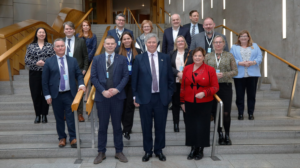MSPs from the Scottish Parliament's Net Zero, Energy and Transport Committee stand on steps for a photograph with MPs of the Icelandic Parliament's Environment and Communication's Committee.